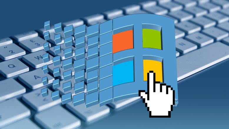 Teclado de computadora con logo superpuesto de Microsoft Windows que tiene cuatro cuadrados de color rojo, verde, azul y amarillo.